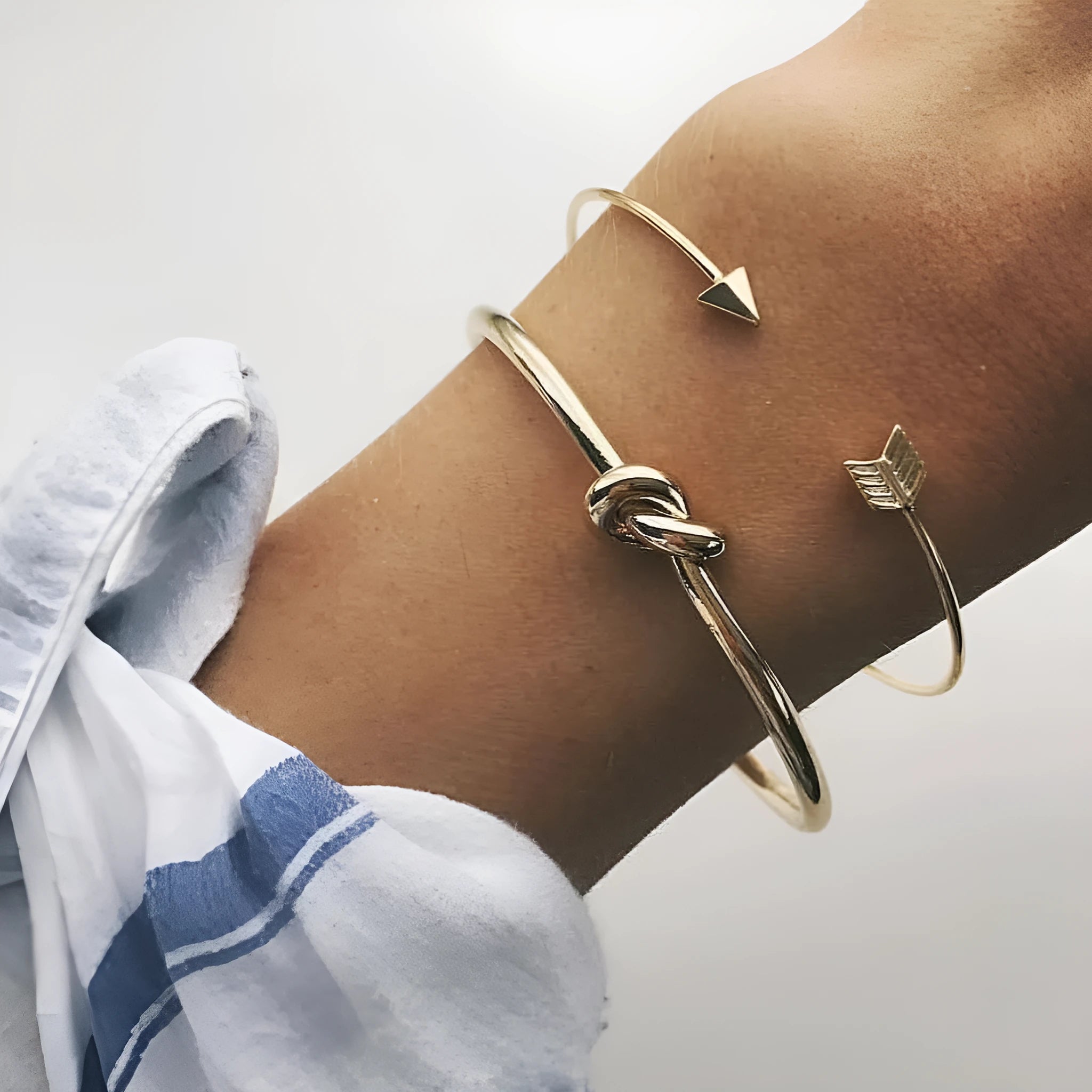 Women's vintage cuff bracelet with arrow knot design in gold electroplated alloy