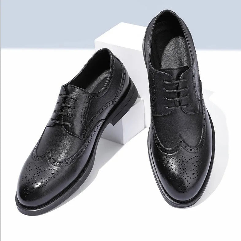 Men's classic black and brown brogue leather shoes with wingtip design on a white background.