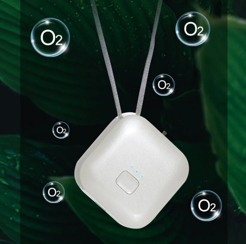 Mini USB portable air purifier necklace in pink, showing compact design with a wearable collar.
