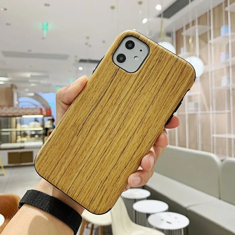 Natural wood grain iPhone back cover case in rosewood finish next to an iPhone