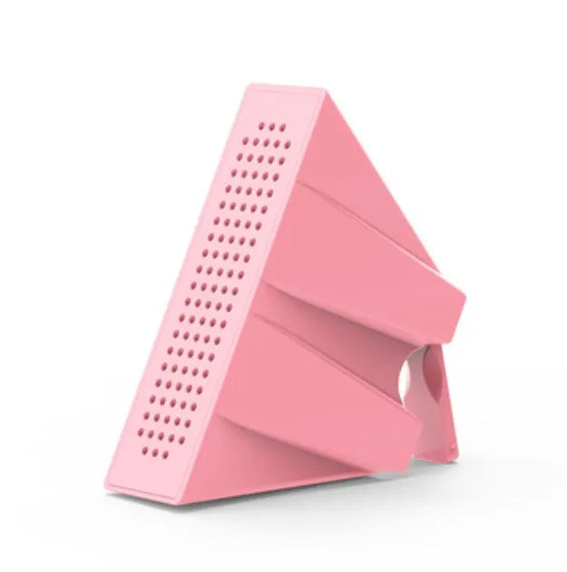 A small, coloured ABS plastic phone amplifier holder on a desktop, holding a mobile phone horizontally.