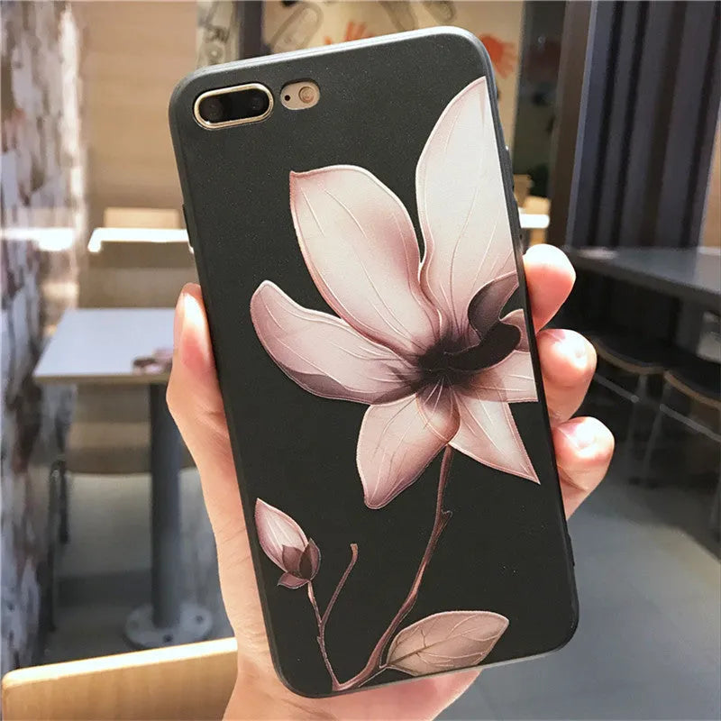 Black embossed iPhone case with a single white floral design on the back.