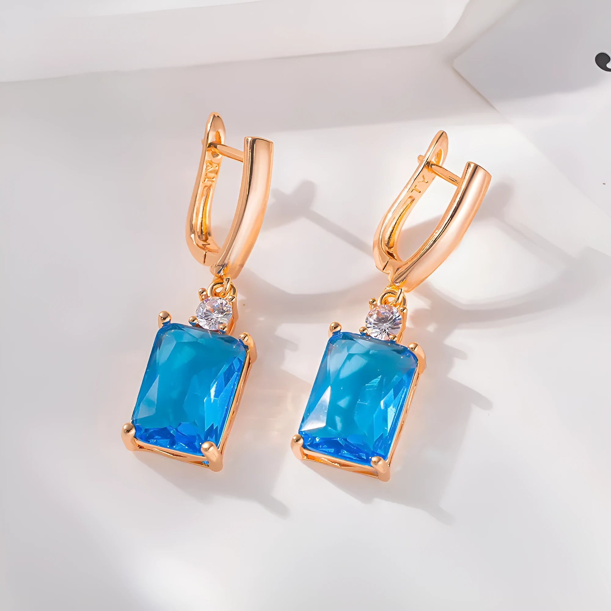 Square geometric copper earrings with electroplated gold finish showing quadrilateral design elements