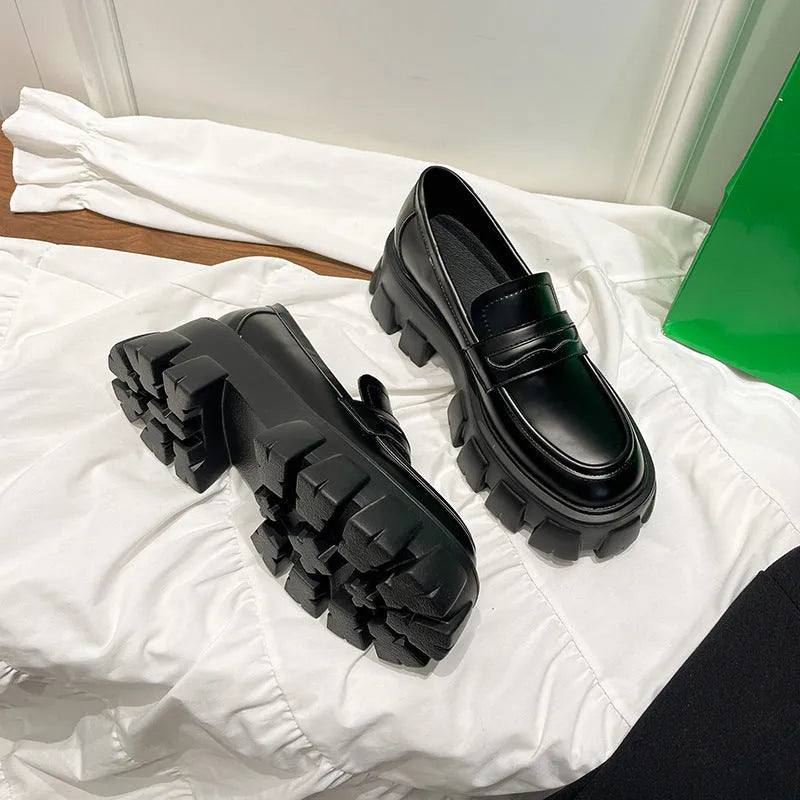 A pair of wide fit leather loafers in a slip-on style with a rubber sole, shown in a choice of finishes.