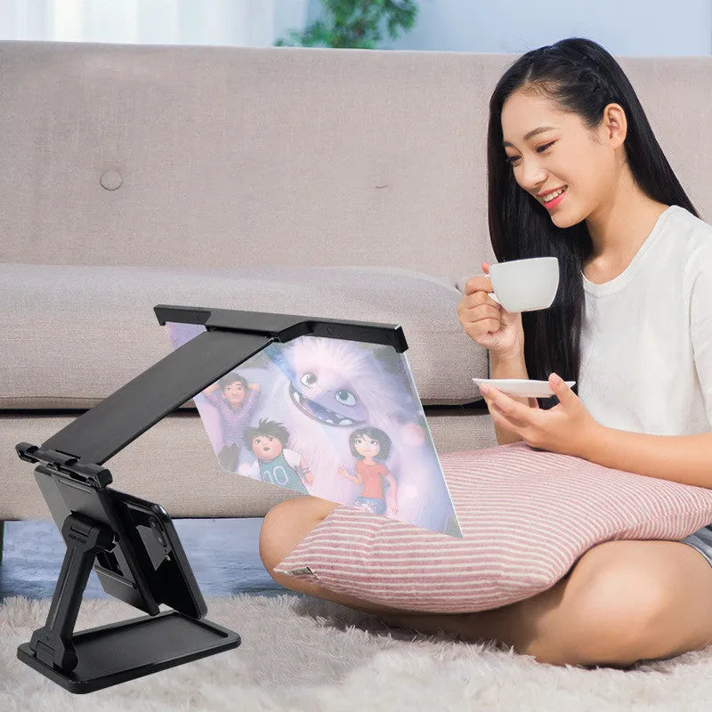 Black L20 split mobile phone screen magnifier with acrylic lens and separate phone bracket on a table.