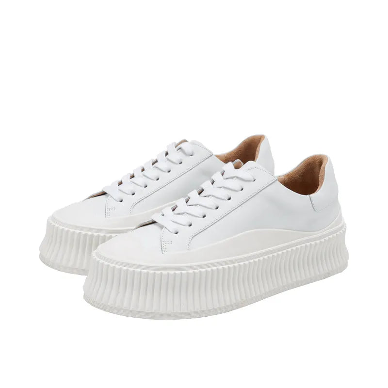 Women's black suede platform shoes with thick soles, back lacing, and a muffin heel on a white background.