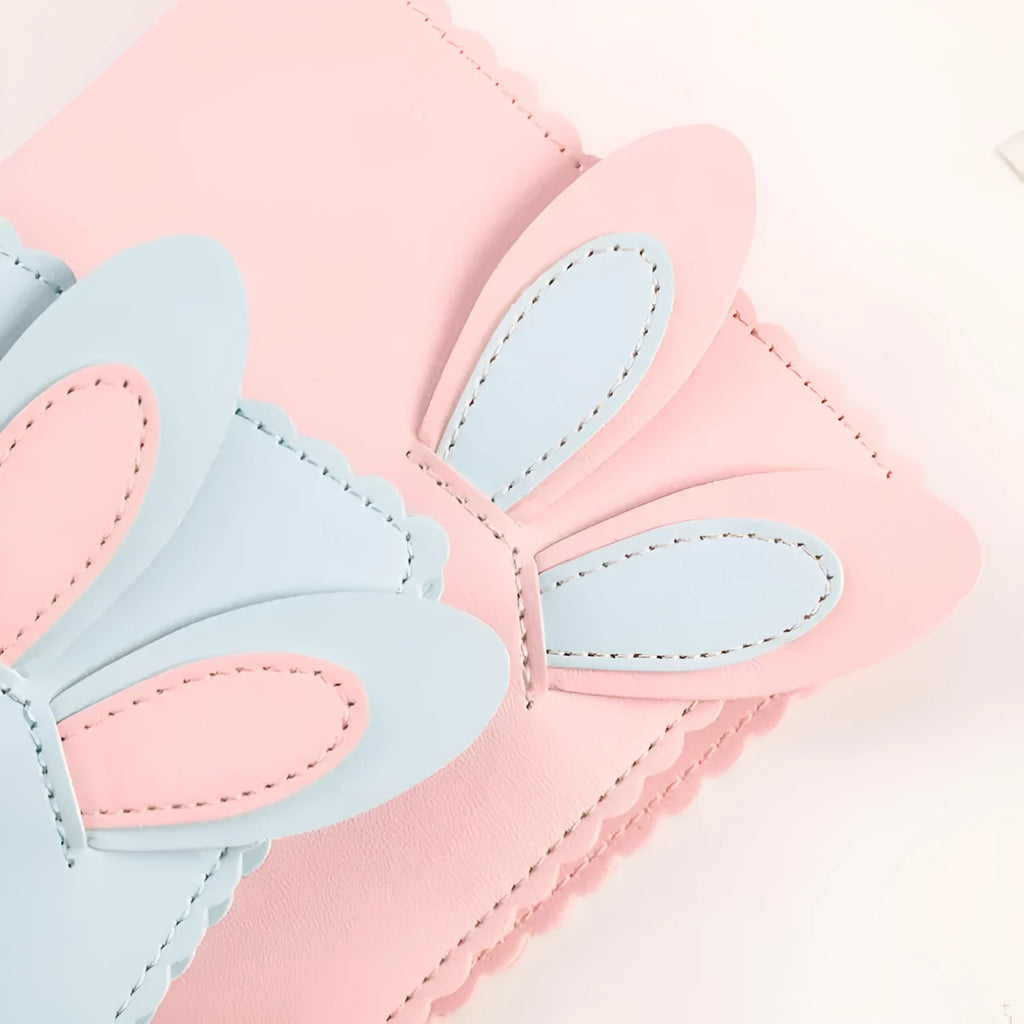 Rabbit style mini photo album in pink, blue, or white showing 3-inch photo slots