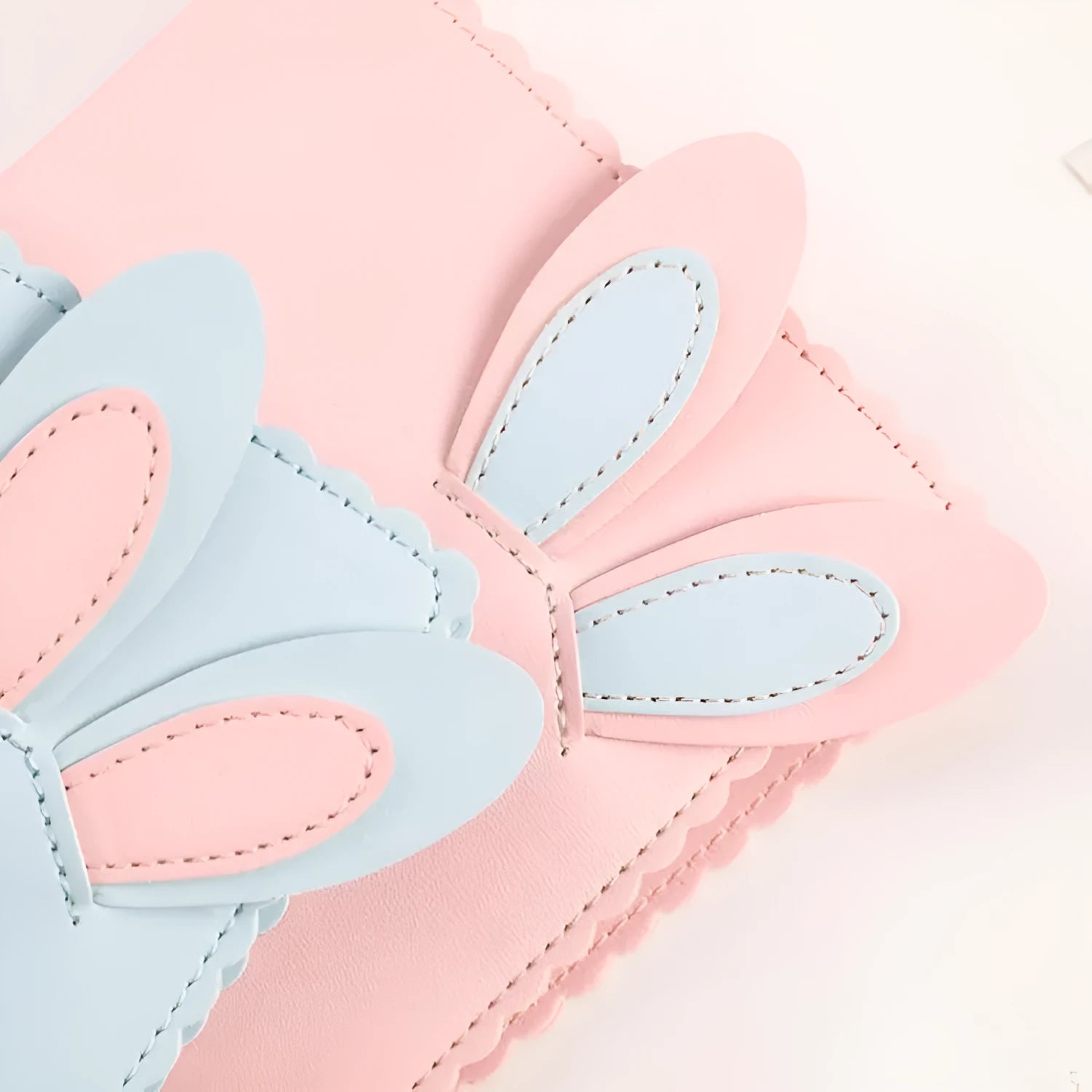 Rabbit style mini photo album in pink, blue, or white showing 3-inch photo slots