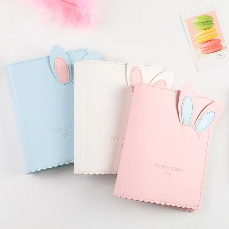 Rabbit style mini photo album in pink, blue, or white showing 3-inch photo slots