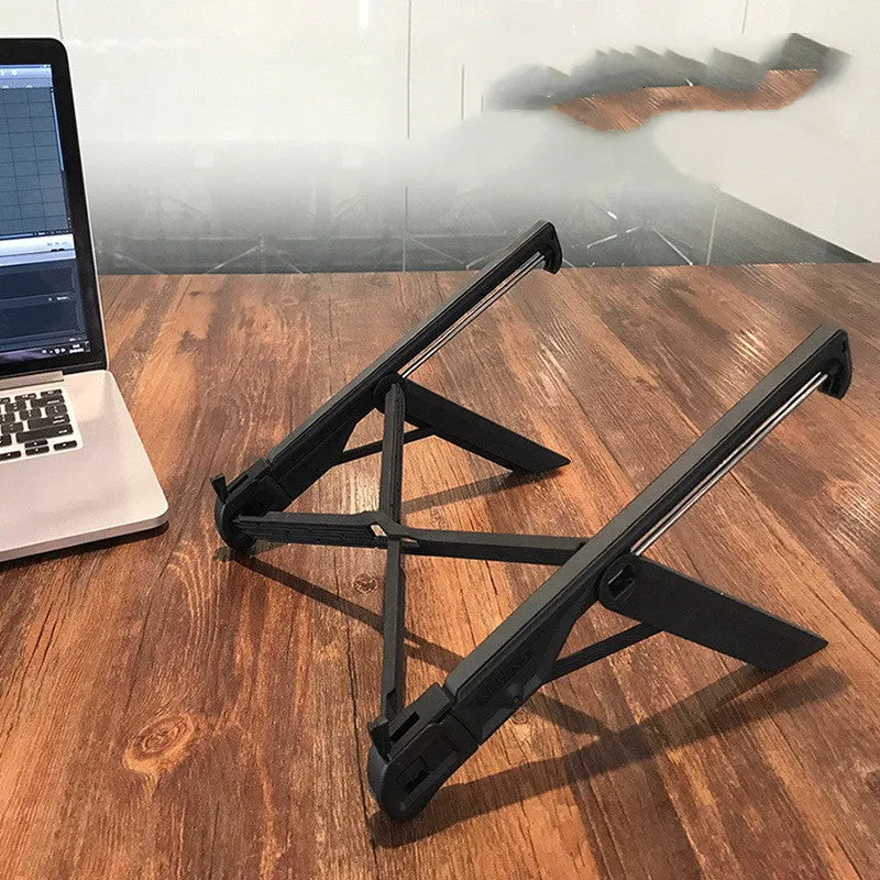 Black folding reinforced nylon portable notebook stand for laptops on a desk