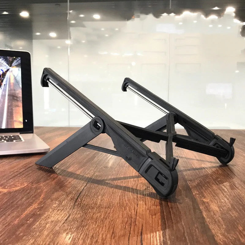 Black folding reinforced nylon portable notebook stand for laptops on a desk