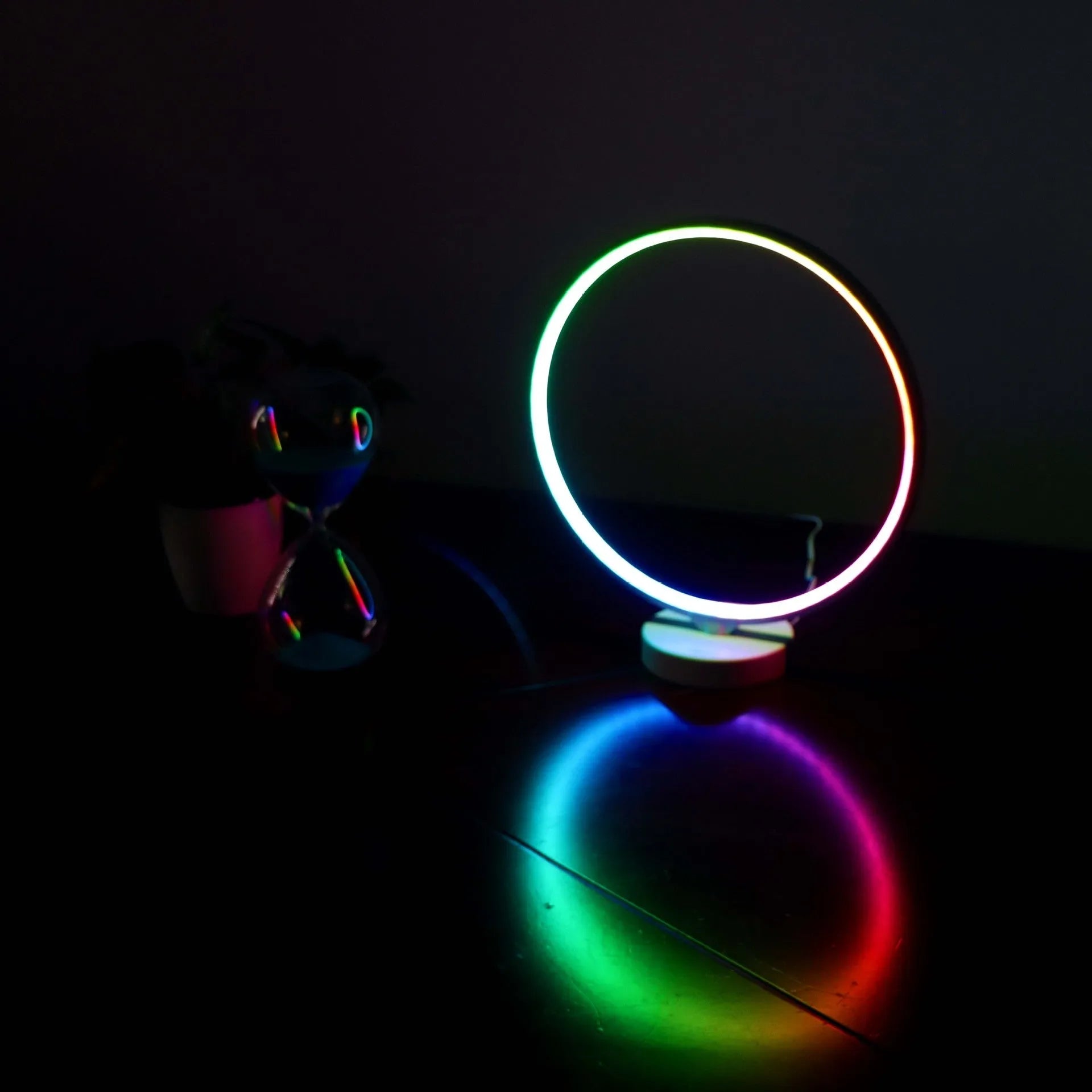 White spherical Full Moon Lamp with remote control on wooden table showing warm white glow