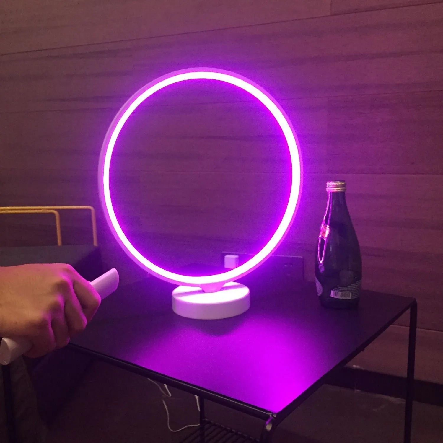 White spherical Full Moon Lamp with remote control on wooden table showing warm white glow