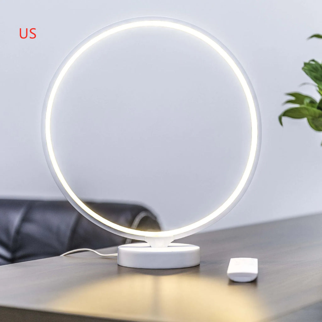 White spherical Full Moon Lamp with remote control on wooden table showing warm white glow