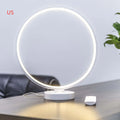 White spherical Full Moon Lamp with remote control on wooden table showing warm white glow