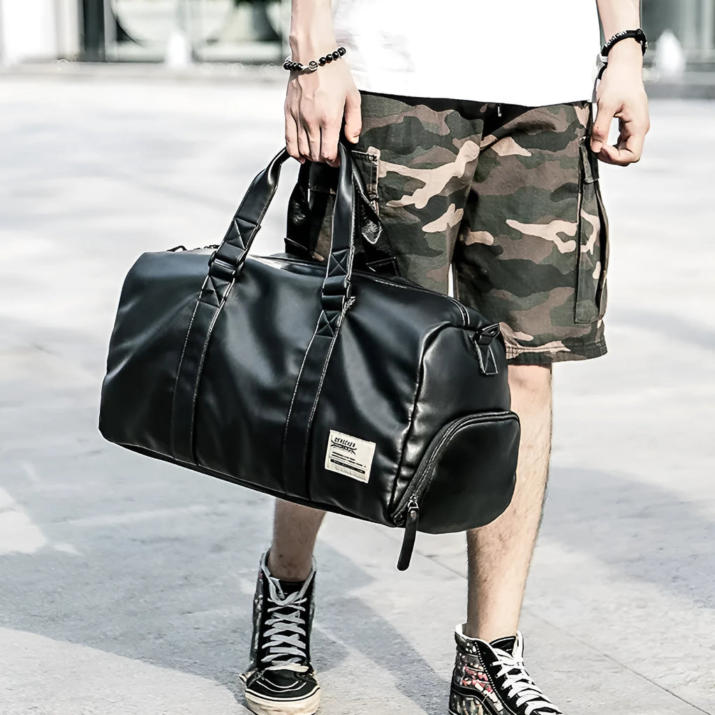 Large black waterproof PU leather sports bag with multiple zipper pockets and a single shoulder strap.