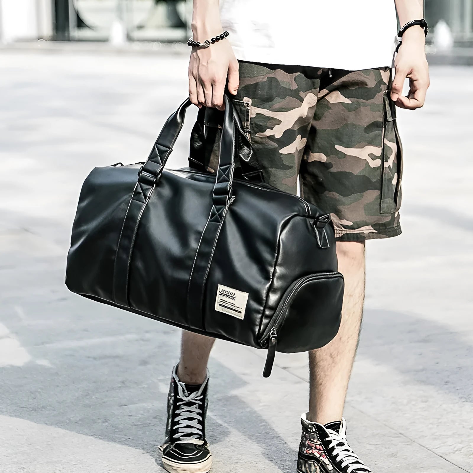 Large black waterproof PU leather sports bag with multiple zipper pockets and a single shoulder strap.