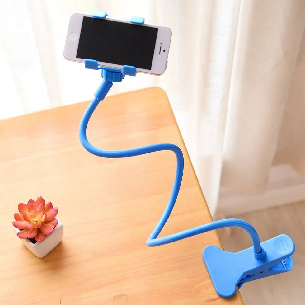 Black portable mobile phone holder with a long flexible arm and a V-clip, extended on a surface.