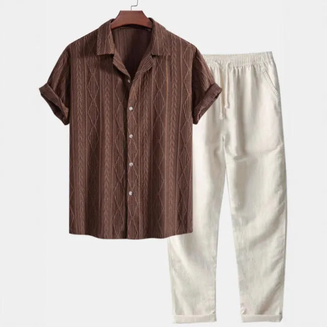 Men's camouflage print casual suit set with short-sleeve lapel shirt and trousers on a hanger.