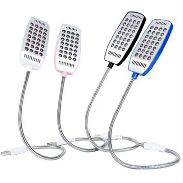 Black flexible USB desk lamp with gooseneck and clip, illuminated on a wooden surface.