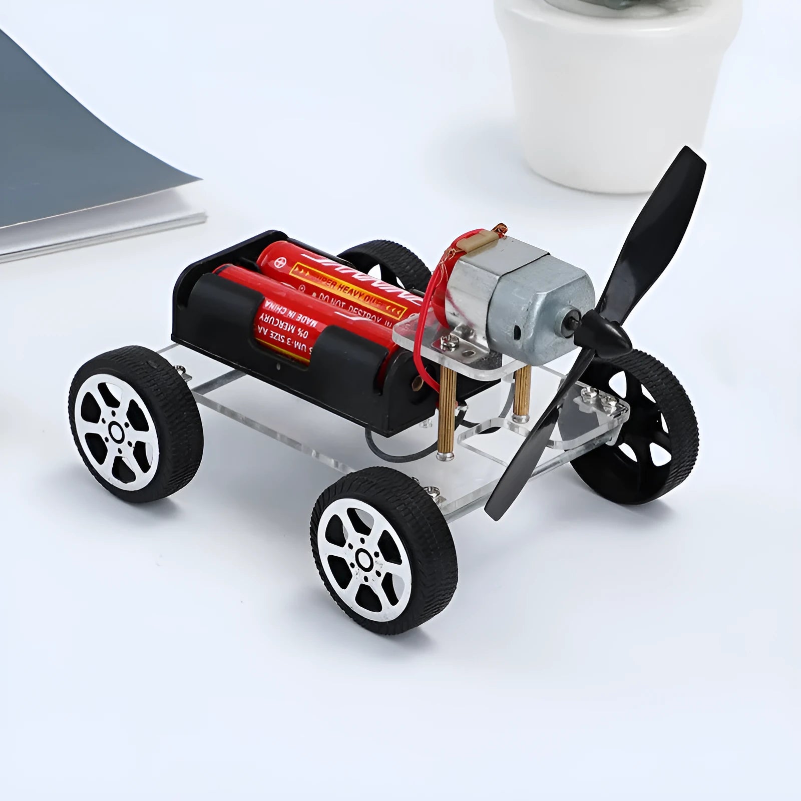 Wind car DIY electronic kit with acrylic metal plastic parts on table