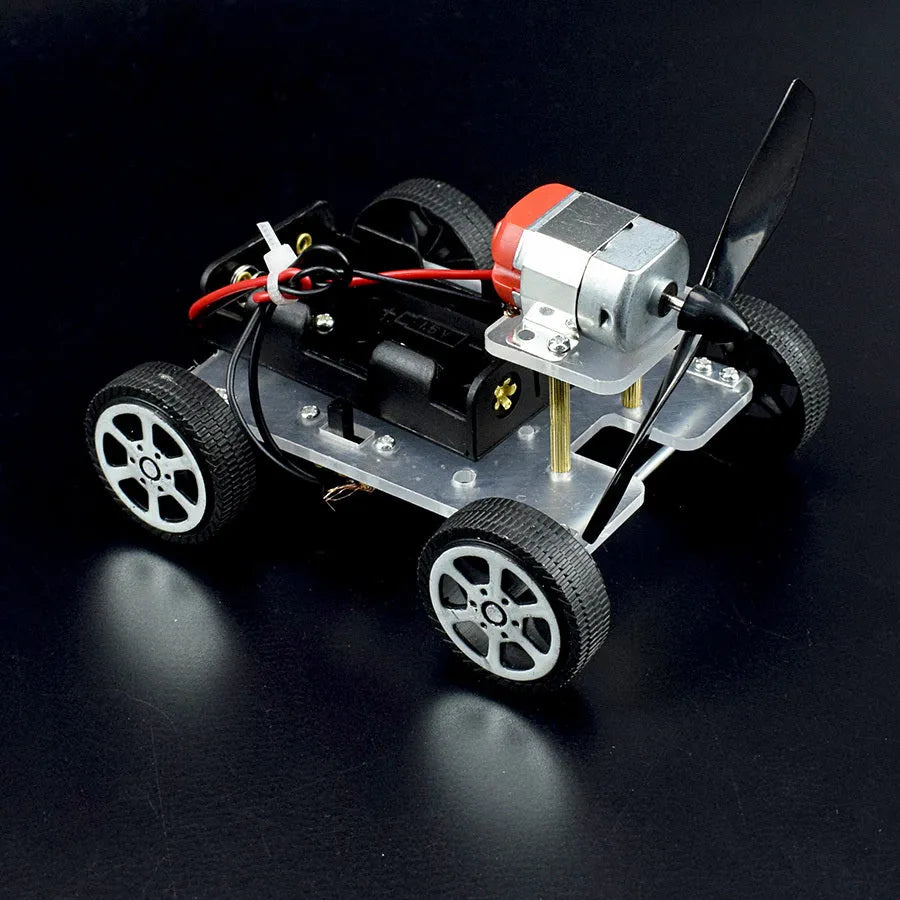 Wind car DIY electronic kit with acrylic metal plastic parts on table