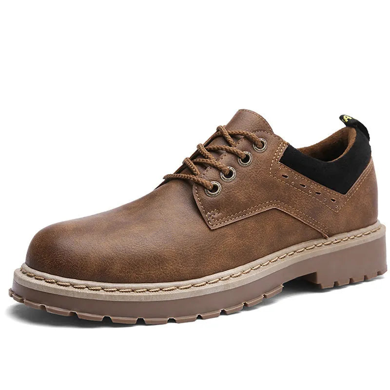 Men's black casual shoes with round toe, flat rubber sole, and front lace-up closure on a plain background.
