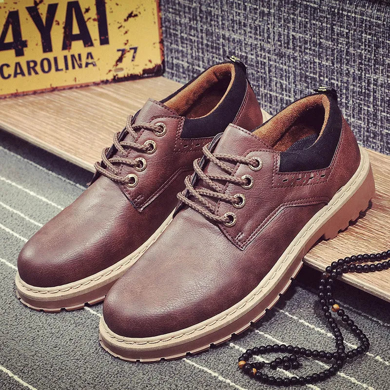 Men's black casual shoes with round toe, flat rubber sole, and front lace-up closure on a plain background.