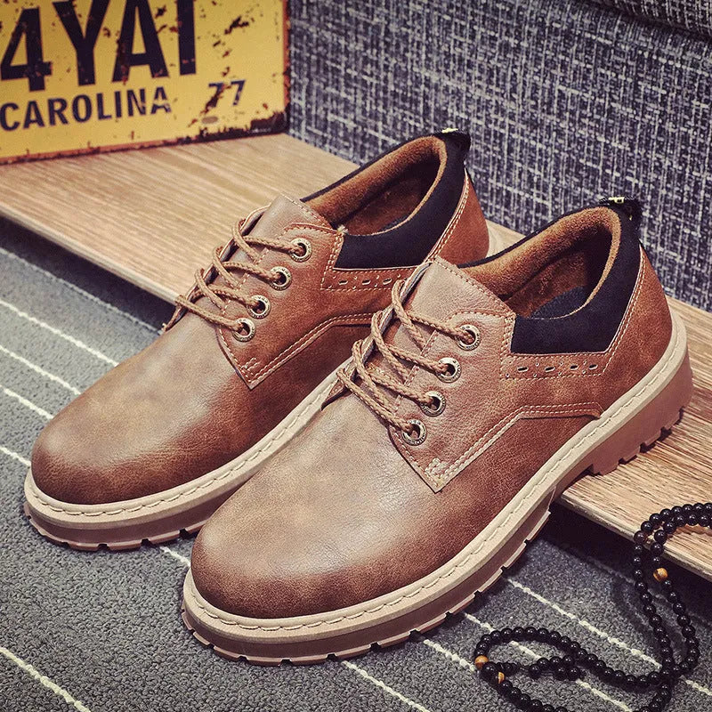 Men's black casual shoes with round toe, flat rubber sole, and front lace-up closure on a plain background.