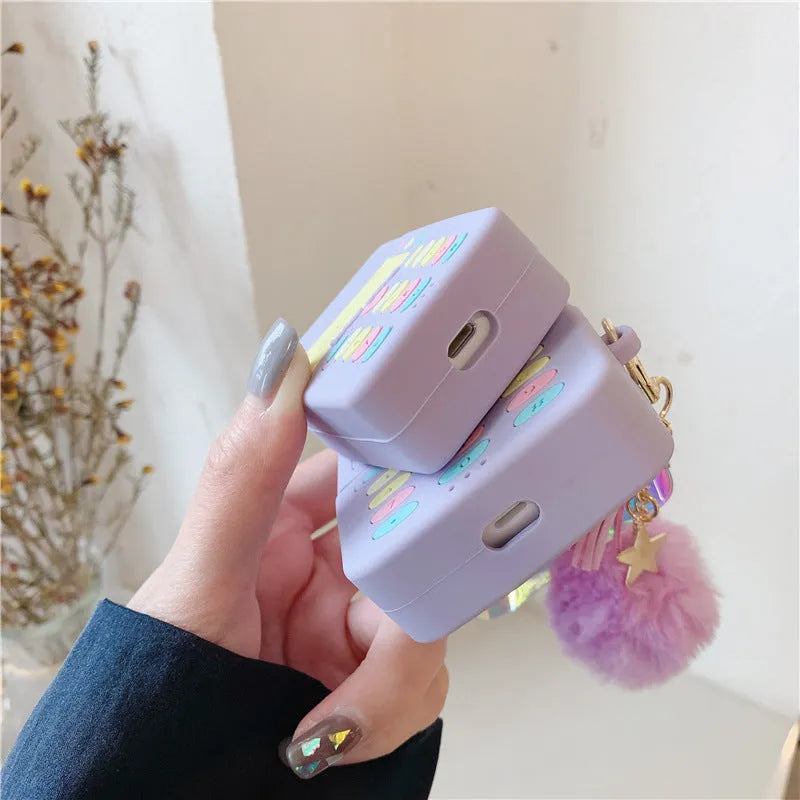 Purple silicone protective case with a fur ball pendant for Apple AirPods Pro and AirPods 1 and 2.