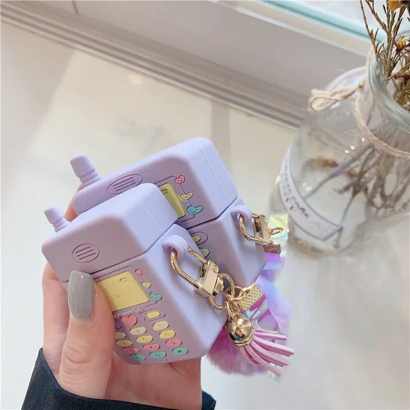 Purple silicone protective case with a fur ball pendant for Apple AirPods Pro and AirPods 1 and 2.