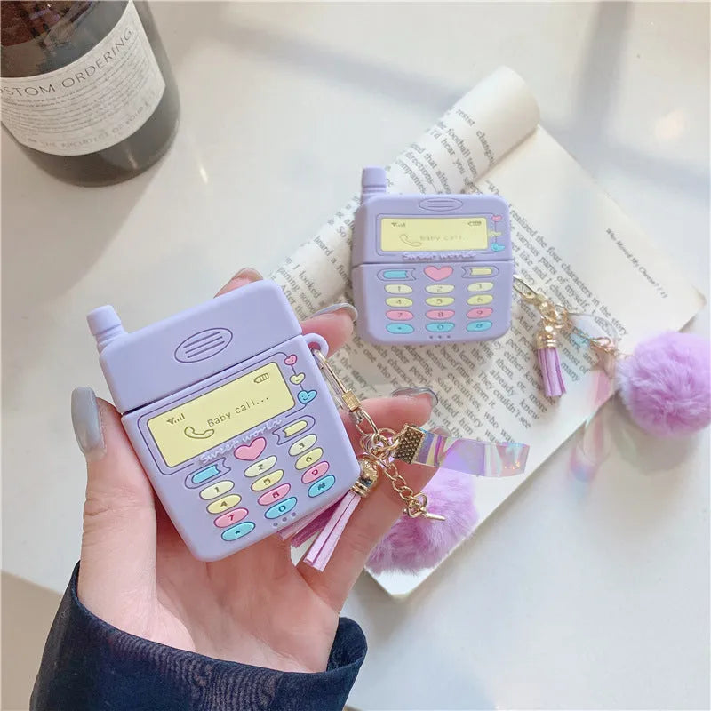 Purple silicone protective case with a fur ball pendant for Apple AirPods Pro and AirPods 1 and 2.