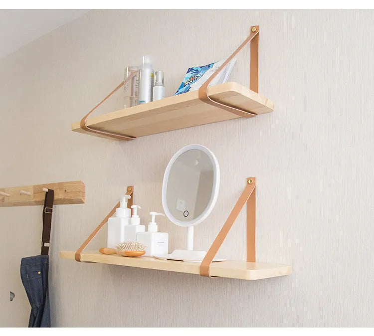 Nordic style pine wood wall shelf measuring 50cm wide, holding remote controls and books