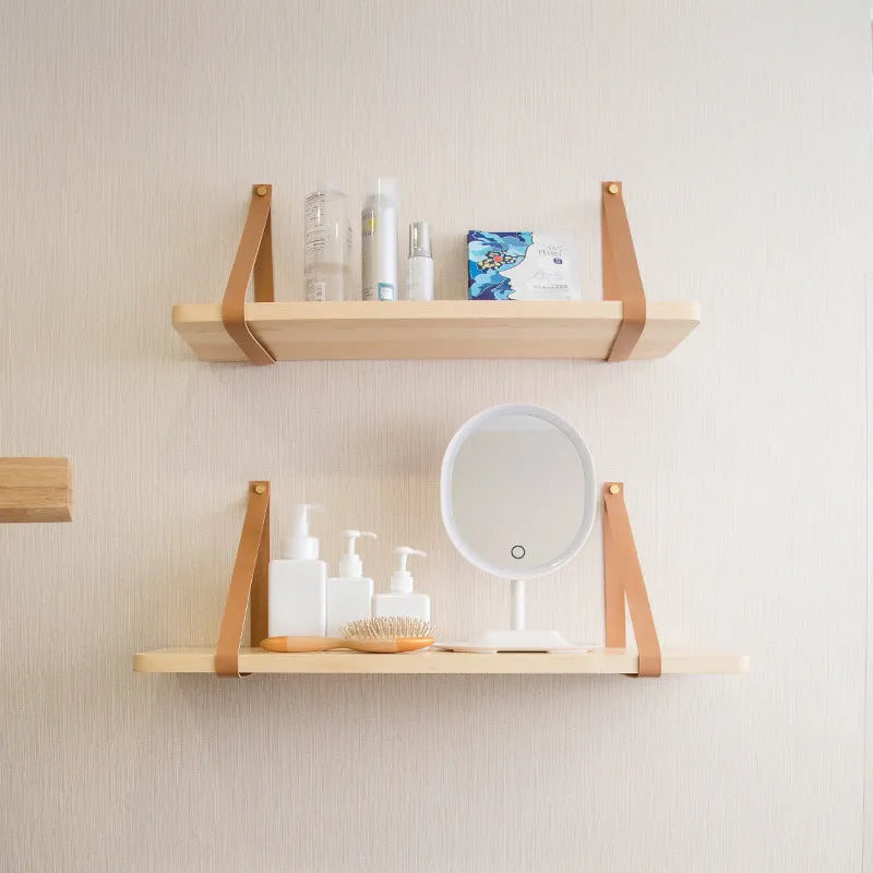 Nordic style pine wood wall shelf measuring 50cm wide, holding remote controls and books
