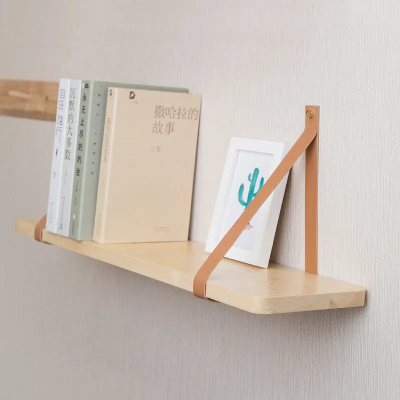 Nordic style pine wood wall shelf measuring 50cm wide, holding remote controls and books