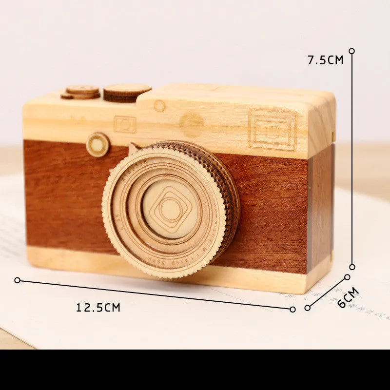Wooden camera-themed music box with rotating mechanism on pine wood base
