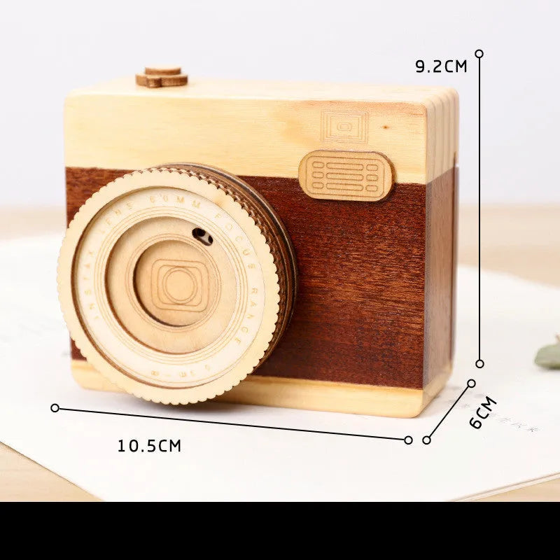 Wooden camera-themed music box with rotating mechanism on pine wood base