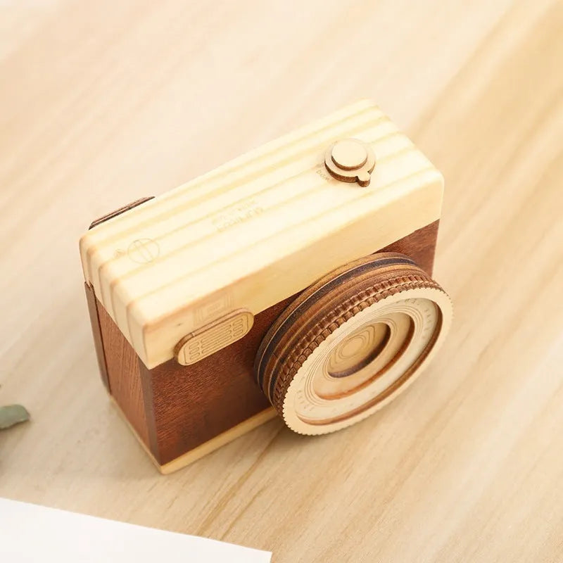 Wooden camera-themed music box with rotating mechanism on pine wood base