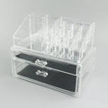 Clear acrylic makeup storage case with transparent sides showing cosmetic organisation