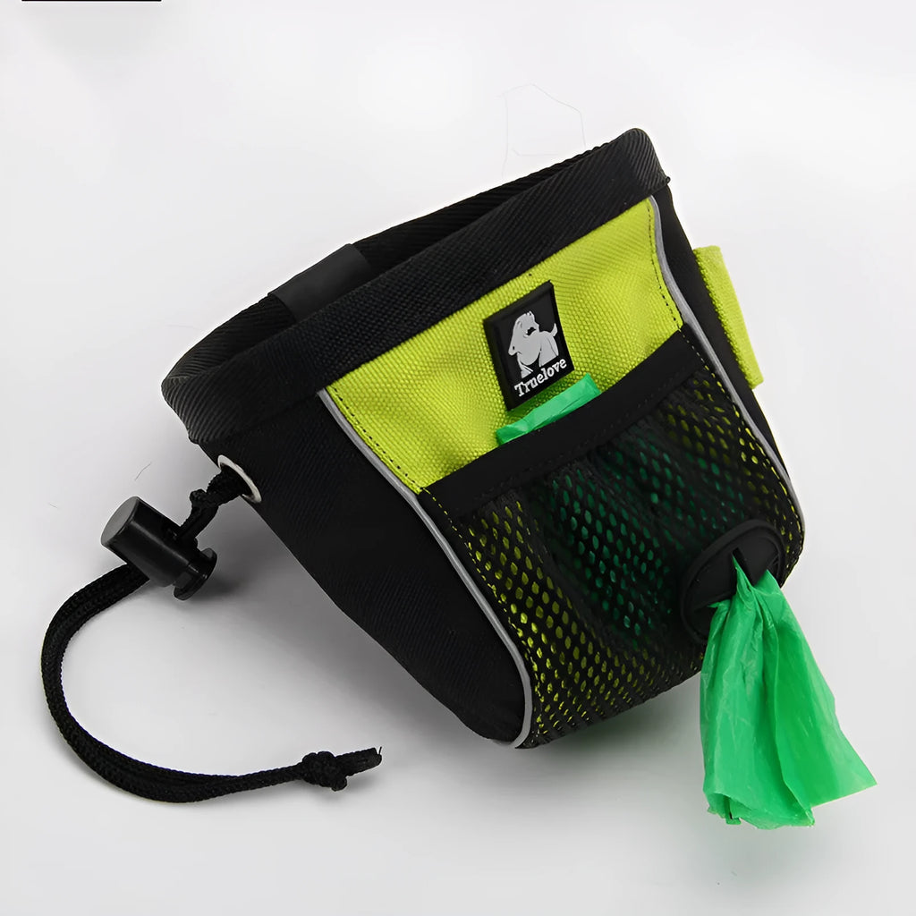 Green waterproof dog training waist bag with a removable waste bag compartment, shown on a person's waist.