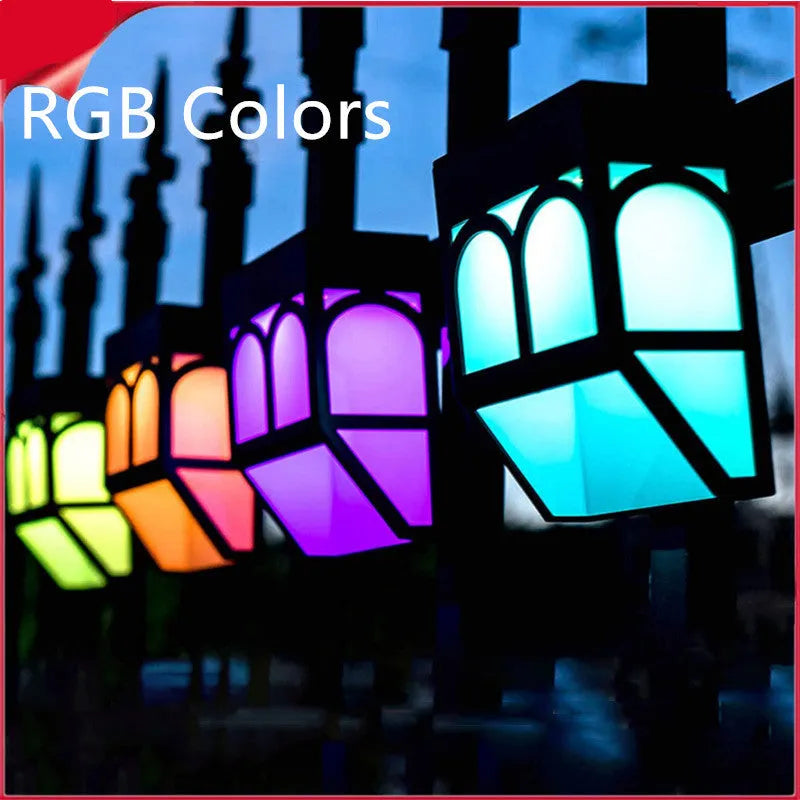 Square white solar-powered outdoor wall lamp with LED light, mounted on a fence post.
