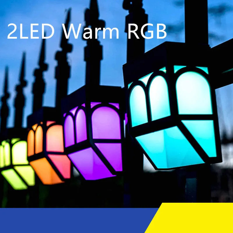 Square white solar-powered outdoor wall lamp with LED light, mounted on a fence post.