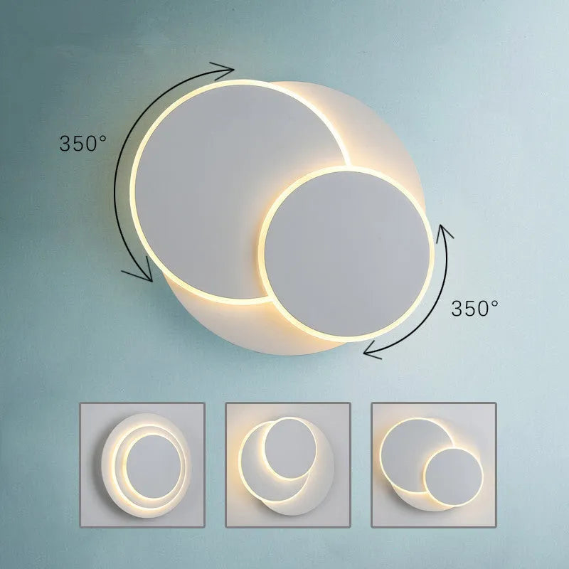 Modern round wall lamp with acrylic shade in black or white finish, available in three sizes with LED lighting