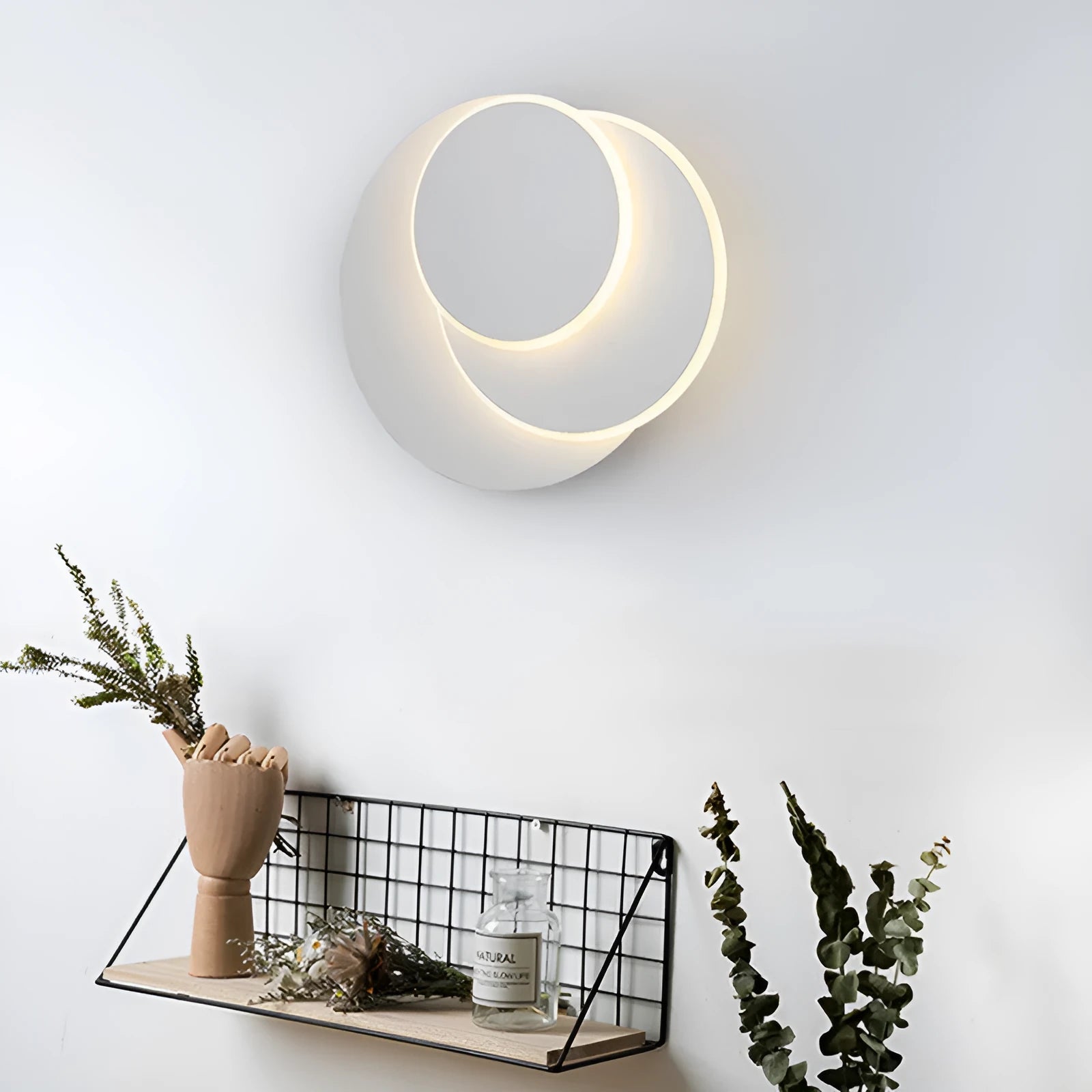 Modern round wall lamp with acrylic shade in black or white finish, available in three sizes with LED lighting