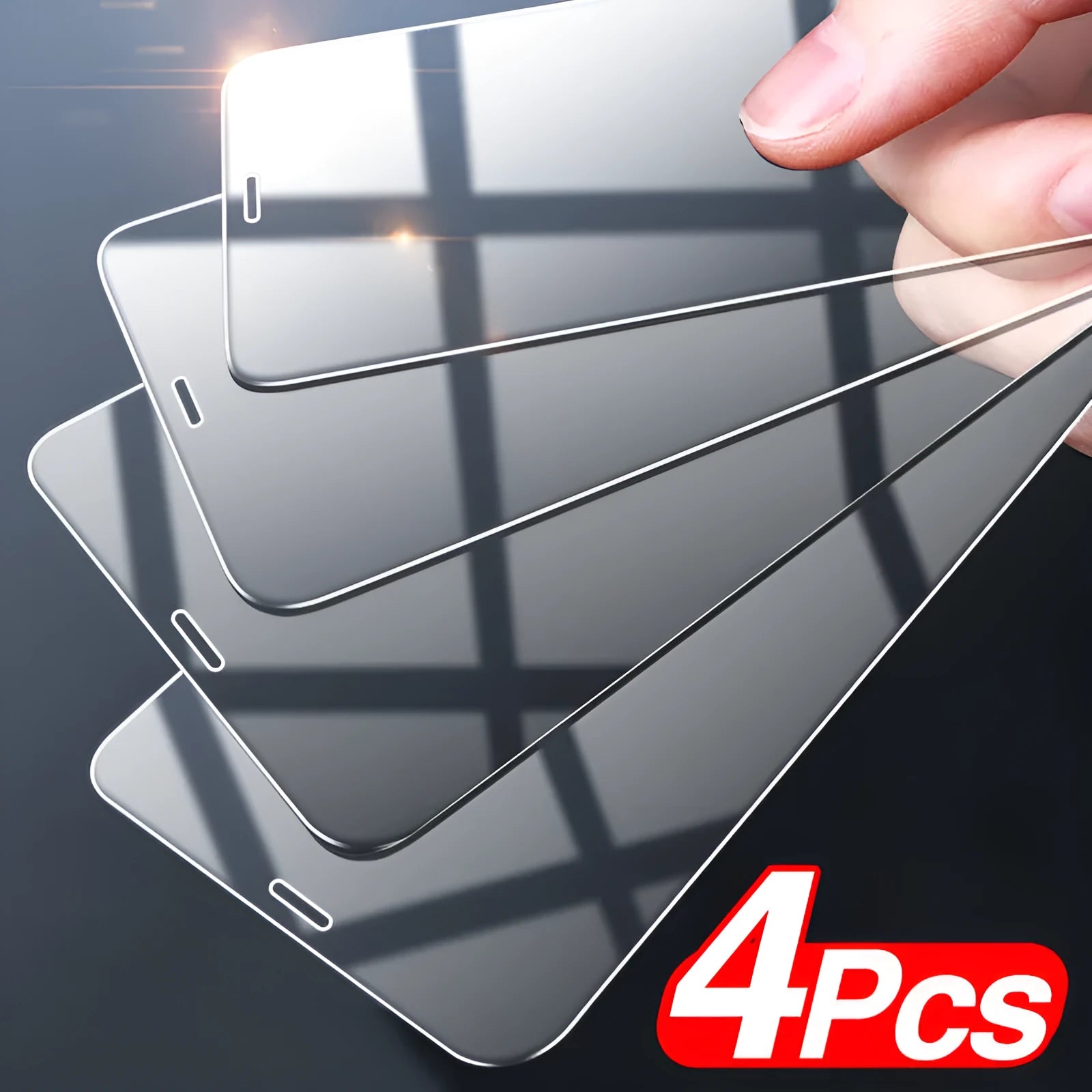 Four transparent tempered glass screen protectors for Apple iPhone models on a clean surface