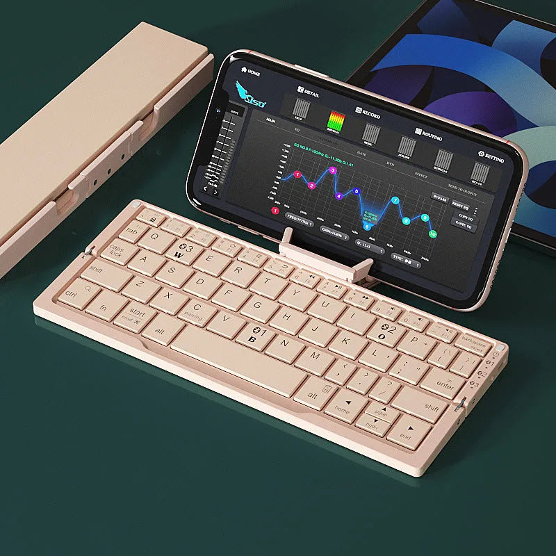 Silver aluminium folding Bluetooth keyboard open with smartphone propped on integrated stand