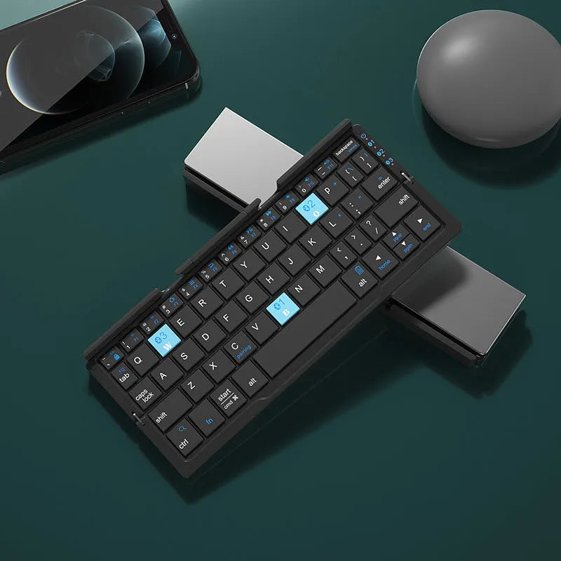 Silver aluminium folding Bluetooth keyboard open with smartphone propped on integrated stand