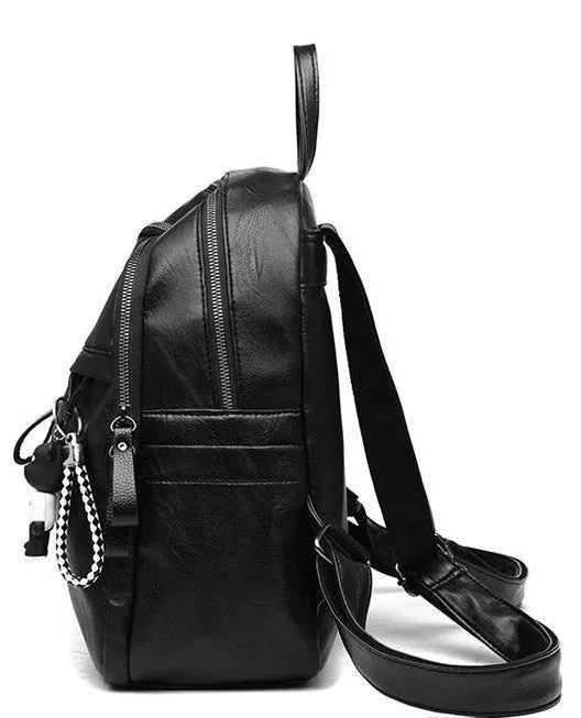 Black PU leather backpack with double shoulder straps showing luggage strap attachment
