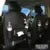 PU leather car storage hanging bag with multiple pockets and built-in trash can mounted on car seat