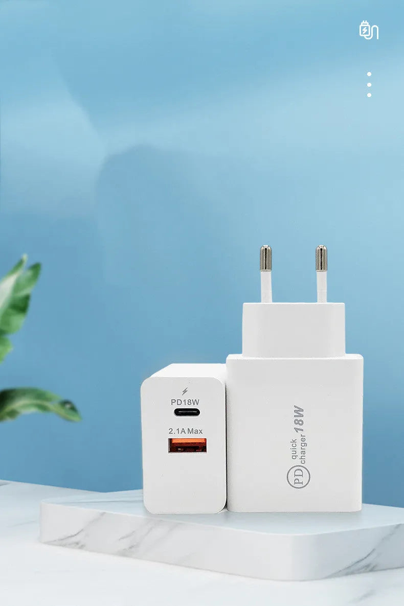 White 18W USB-C PD fast wall charger with US plug on a wooden surface.